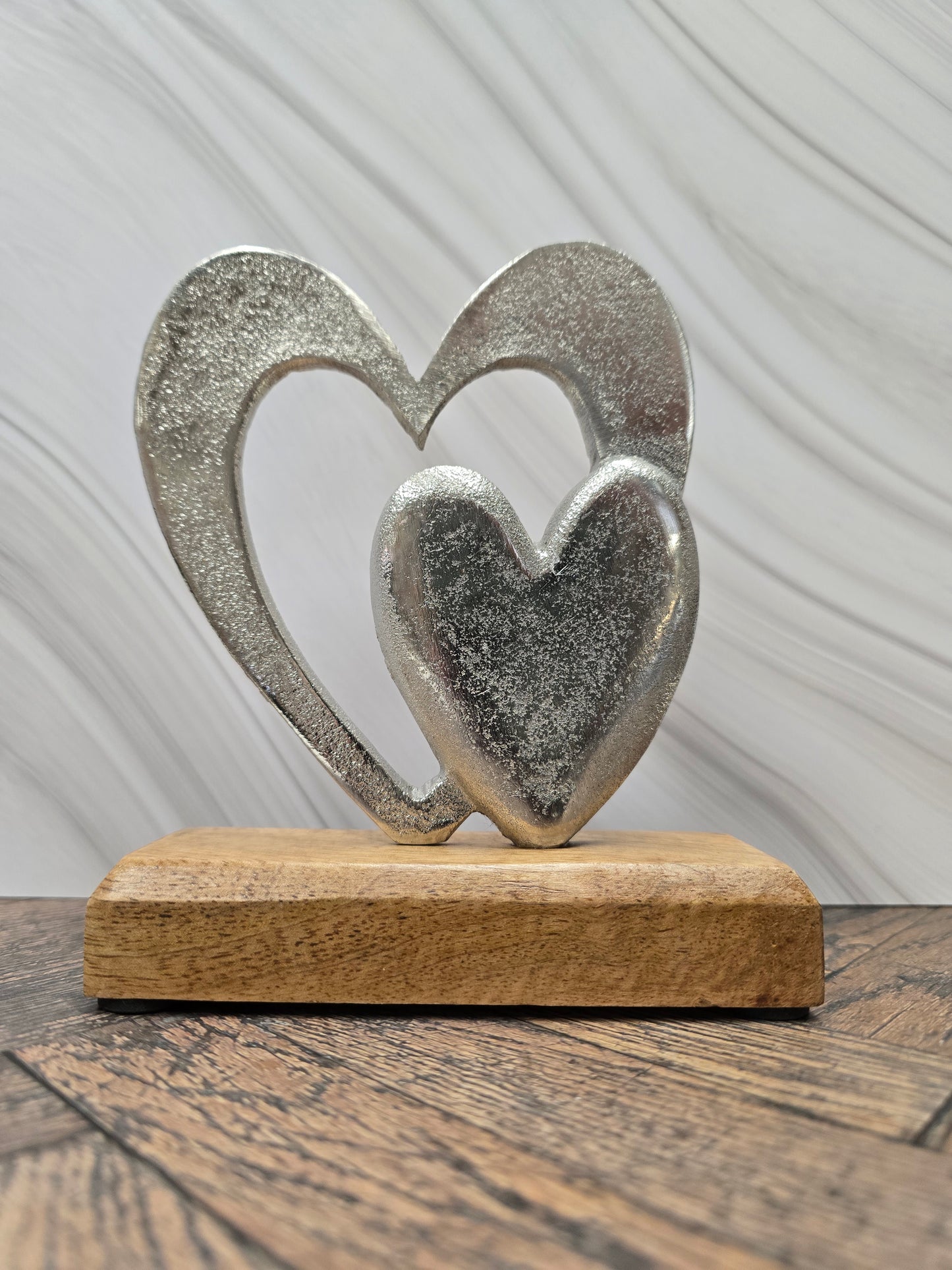 Double hearts on wooden base